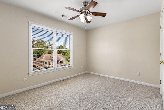 carpeted spare room with baseboards and ceiling fan