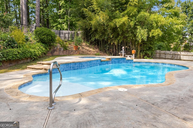 view of pool with a fenced backyard, an in-ground hot tub, and a patio area