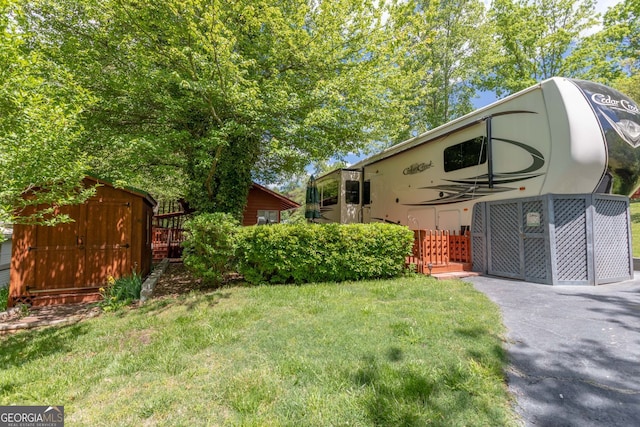 43 Tip Top Cir, Cleveland, GA 30528 - view of grassy yard featuring an outdoor structure and a storage shed