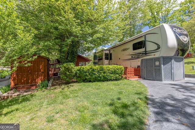 43 Tip Top Cir, Cleveland, GA 30528 - view of grassy yard with a storage shed and an outdoor structure