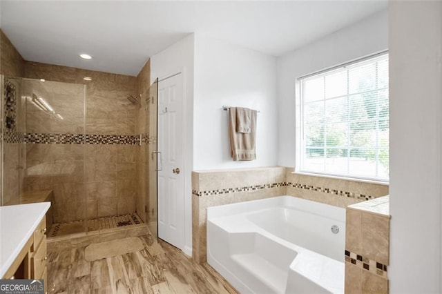 bathroom featuring a bath, a stall shower, vanity, and recessed lighting