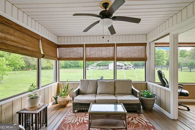 sunroom / solarium with ceiling fan and outdoor lounge area