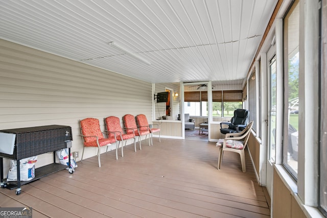 sunroom / solarium featuring healthy amount of natural light