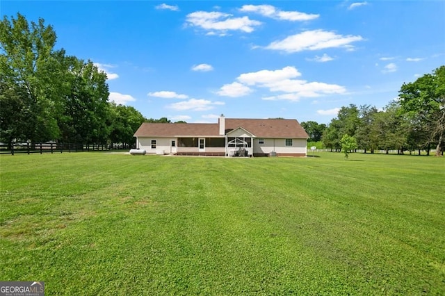 rear view of property featuring a chimney