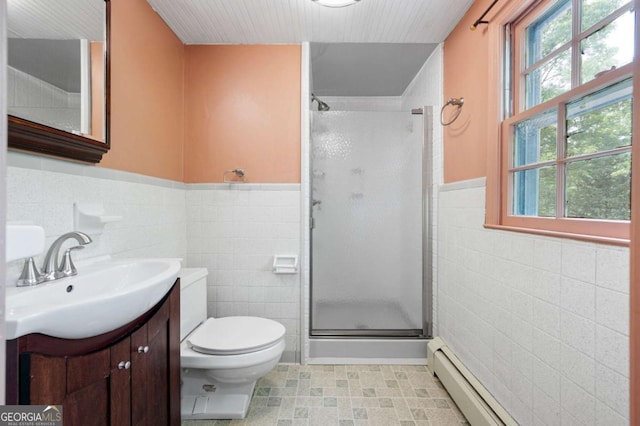 bathroom with tile walls, a shower stall, vanity, healthy amount of natural light, and toilet