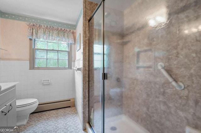 bathroom featuring a baseboard radiator, vanity, a shower stall, tile walls, and a wainscoted wall