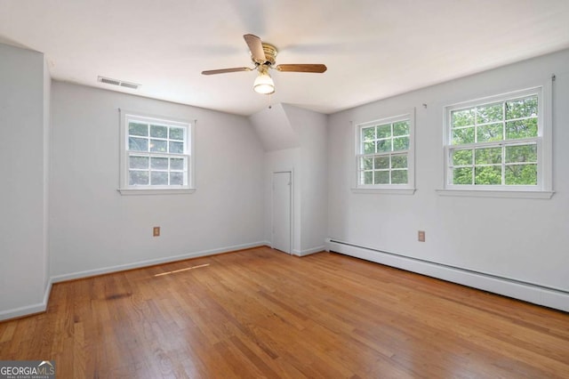 bonus room with a baseboard radiator, wood finished floors, baseboards, and a ceiling fan