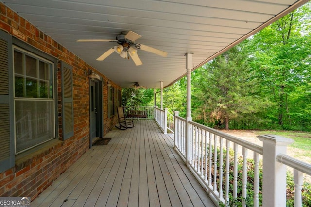 wooden terrace featuring ceiling fan and a porch