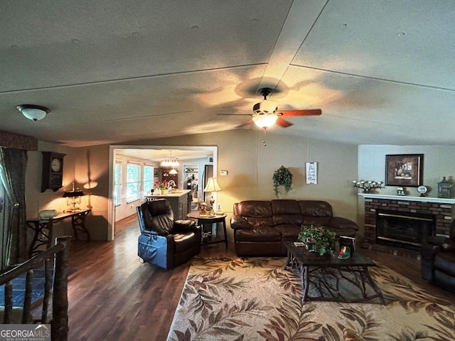 317 Cedar Dr NW, Sparta, GA 31087 - living room with wood finished floors, a brick fireplace, a ceiling fan, and vaulted ceiling