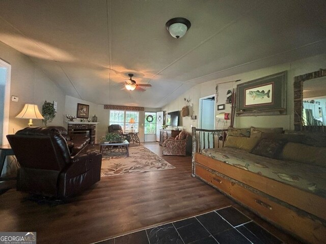317 Cedar Dr NW, Sparta, GA 31087 - living room with lofted ceiling, a fireplace, a ceiling fan, and wood finished floors