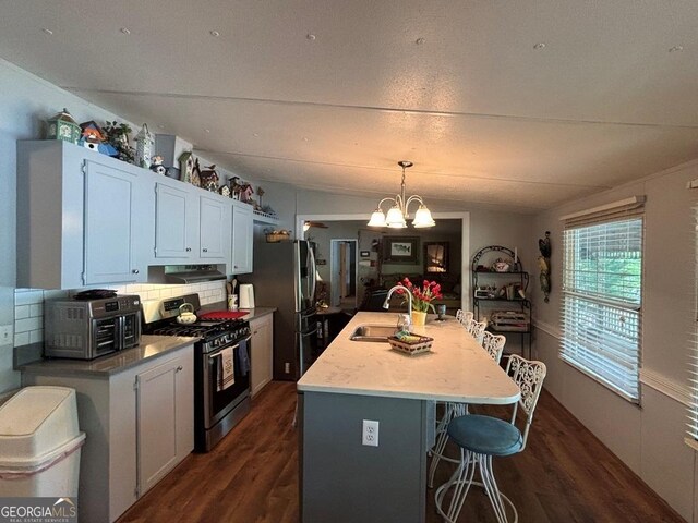 317 Cedar Dr NW, Sparta, GA 31087 - kitchen with stainless steel appliances, a sink, dark wood-style flooring, and under cabinet range hood