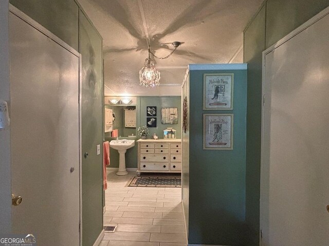 317 Cedar Dr NW, Sparta, GA 31087 - corridor featuring a chandelier