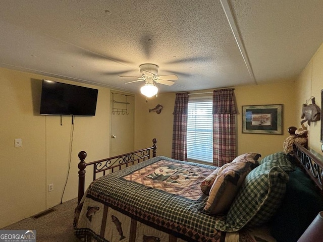 317 Cedar Dr NW, Sparta, GA 31087 - carpeted bedroom with a textured ceiling and ceiling fan