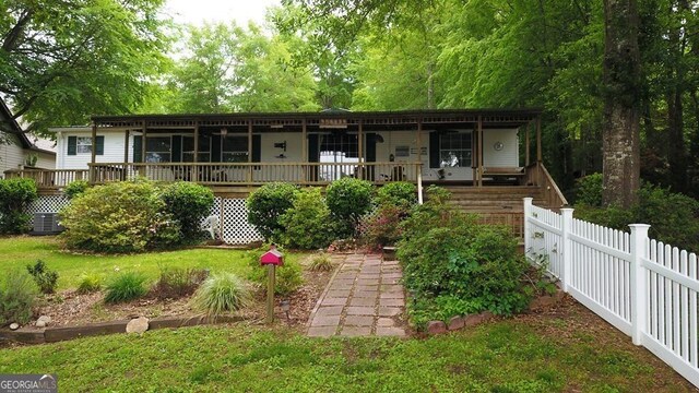 317 Cedar Dr NW, Sparta, GA 31087 - ranch-style home with cooling unit and covered porch
