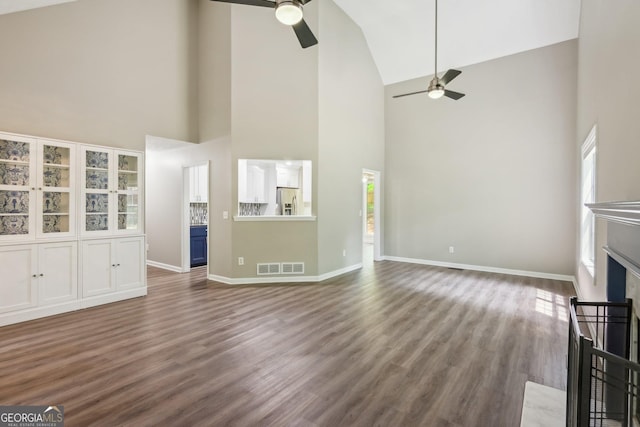 7675 Rose Ln, Cumming, GA 30040 - unfurnished living room featuring ceiling fan, high vaulted ceiling, baseboards, wood finished floors, and a fireplace with flush hearth