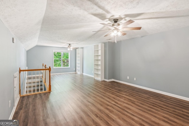 7675 Rose Ln, Cumming, GA 30040 - unfurnished room with a textured ceiling, ceiling fan, wood finished floors, baseboards, and vaulted ceiling