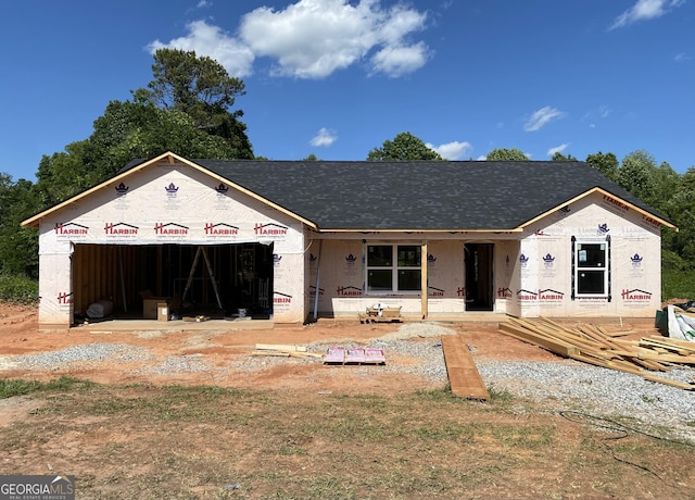 property under construction with a shingled roof, a garage, and a porch