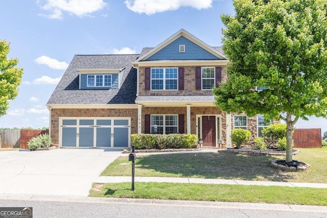 1903 Henderson Falls Way, Braselton, GA 30517 - view of front of house featuring driveway, stone siding, and a porch