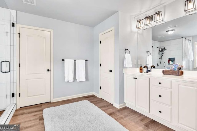 1903 Henderson Falls Way, Braselton, GA 30517 - bathroom featuring a stall shower, double vanity, wood finished floors, and baseboards