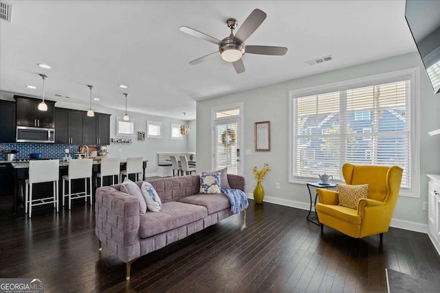 living room with a ceiling fan, dark wood-style flooring, baseboards, and recessed lighting