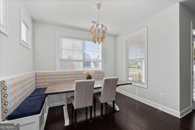 2100 Drew Dr NW, Atlanta, GA 30318 - dining room featuring breakfast area, dark wood-style floors, a chandelier, and baseboards