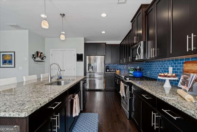 2100 Drew Dr NW, Atlanta, GA 30318 - kitchen featuring stainless steel appliances, a sink, light stone countertops, decorative backsplash, and recessed lighting