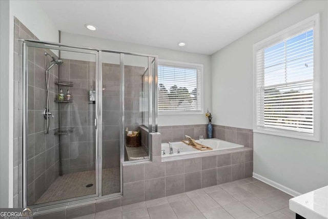 bathroom featuring a shower stall, tile patterned floors, a bath, healthy amount of natural light, and recessed lighting