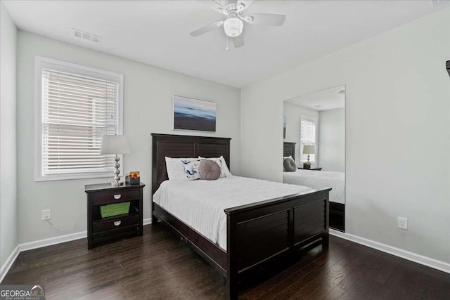 bedroom featuring baseboards, wood finished floors, and a ceiling fan