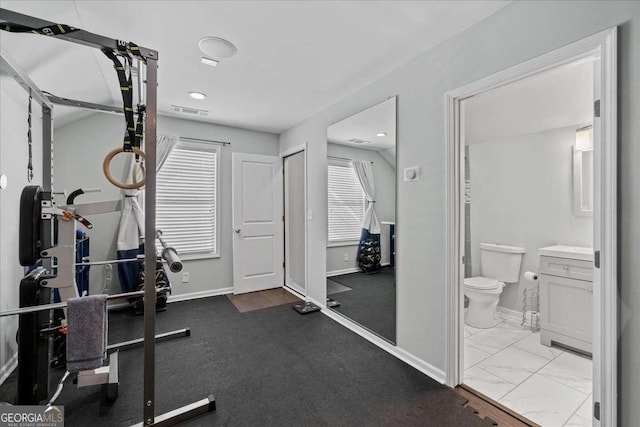 workout room featuring baseboards