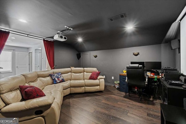 home theater with dark wood-style flooring, lofted ceiling, and recessed lighting