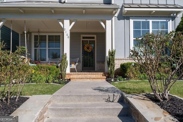 property entrance with a standing seam roof, a porch, and metal roof