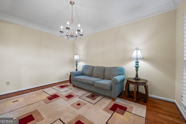 living area with wood finished floors, a chandelier, crown molding, and baseboards