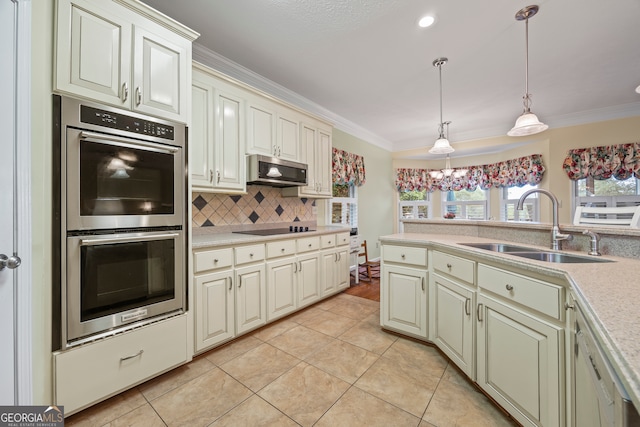 kitchen featuring stainless steel appliances, a sink, light tile patterned floors, decorative backsplash, and light countertops