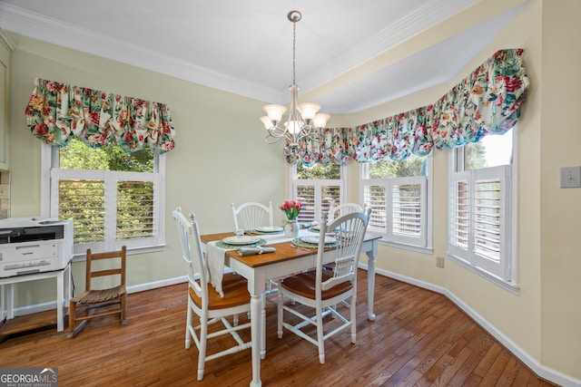 dining area featuring crown molding, hardwood / wood-style flooring, baseboards, a chandelier, and plenty of natural light