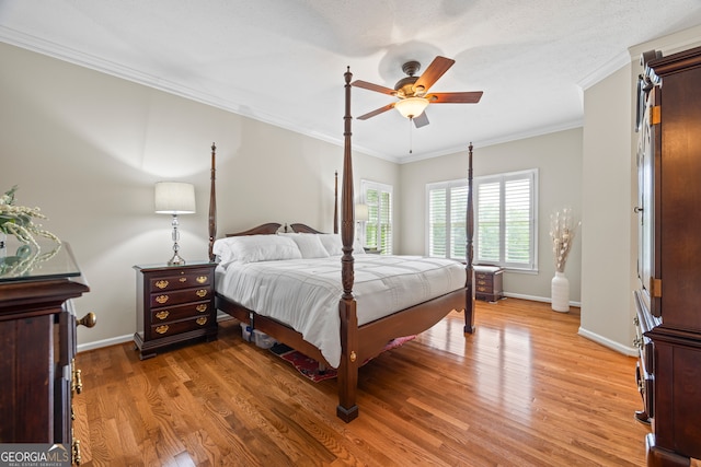 bedroom with baseboards, light wood-type flooring, crown molding, and a ceiling fan