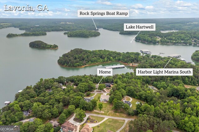 bird's eye view of a nearby body of water and a heavily wooded area
