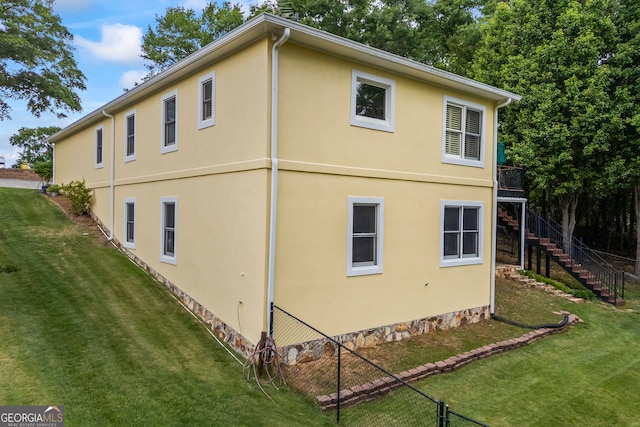 view of home's exterior featuring stairs and stucco siding