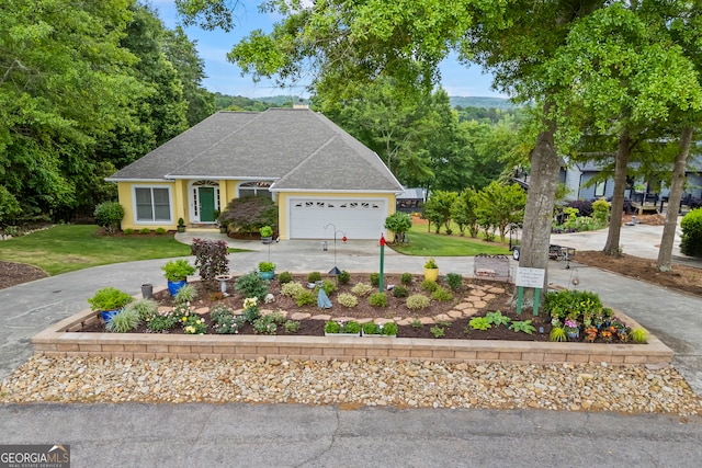 view of front of home with driveway, a front lawn, a shingled roof, and an attached garage