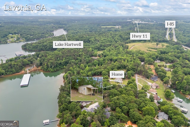 view of property location with a forest, a nearby body of water, and property boundaries highlighted