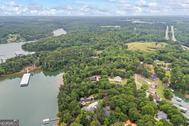 bird's eye view of a nearby body of water and a heavily wooded area