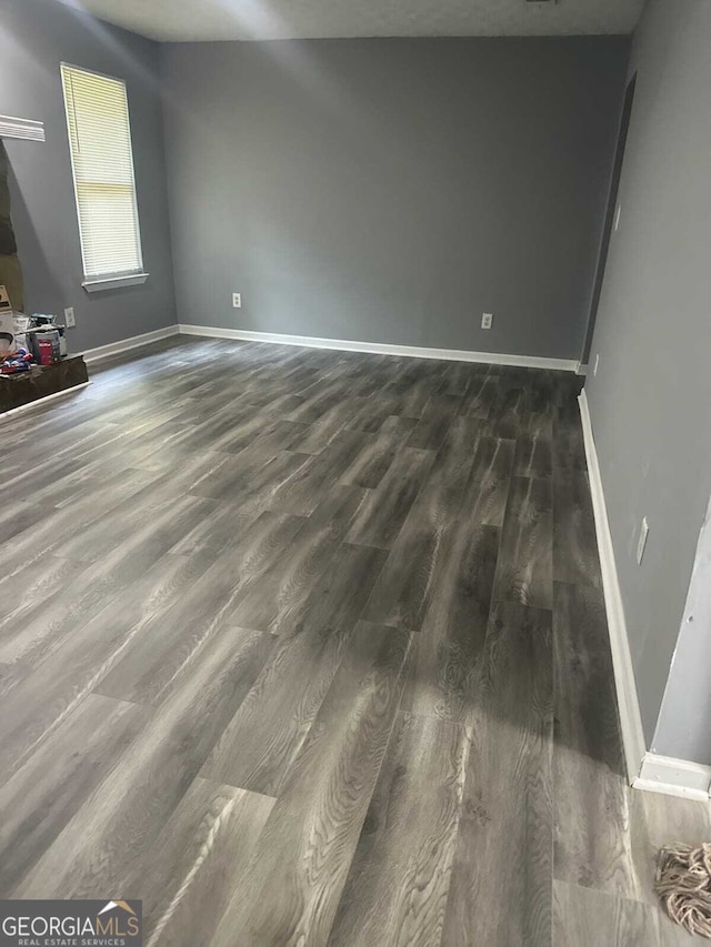 324 Cynthia Ct, Jonesboro, GA 30238 - empty room featuring dark wood-style floors and baseboards
