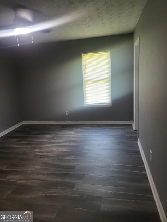 324 Cynthia Ct, Jonesboro, GA 30238 - empty room featuring dark wood-style flooring, baseboards, and a textured ceiling
