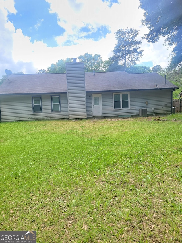 324 Cynthia Ct, Jonesboro, GA 30238 - view of front of property featuring a chimney, a front yard, and central AC