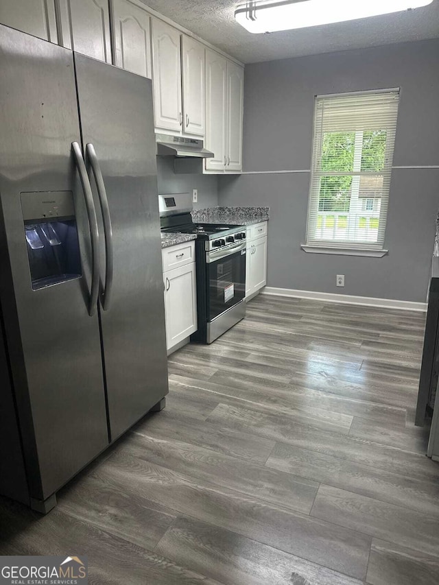 324 Cynthia Ct, Jonesboro, GA 30238 - kitchen featuring appliances with stainless steel finishes, under cabinet range hood, white cabinetry, and baseboards