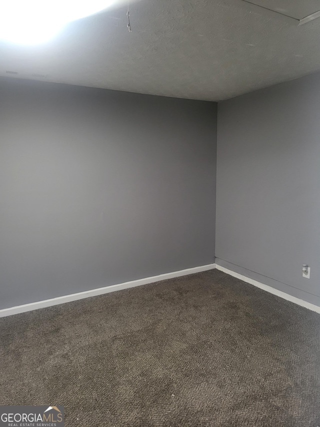 324 Cynthia Ct, Jonesboro, GA 30238 - spare room with dark colored carpet and baseboards
