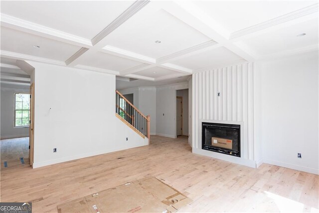 4222 Matisse Ln, Fairburn, GA 30213 - unfurnished living room with coffered ceiling, stairway, a large fireplace, wood finished floors, and beamed ceiling