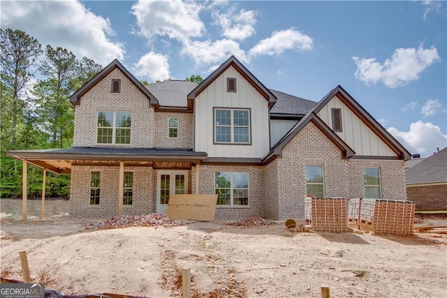 4222 Matisse Ln, Fairburn, GA 30213 - rear view of house with board and batten siding, brick siding, and a shingled roof