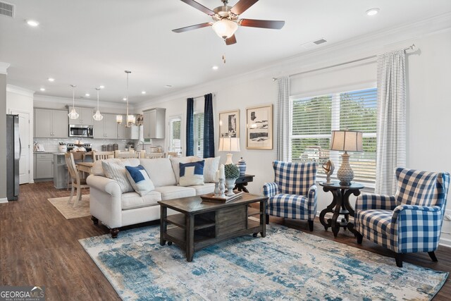 living room featuring ornamental molding, healthy amount of natural light, dark wood finished floors, ceiling fan, and recessed lighting