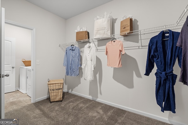 spacious closet with washing machine and dryer and carpet