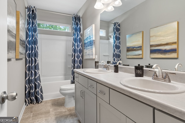 bathroom featuring double vanity, toilet, baseboards, and shower / tub combo with curtain